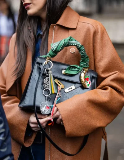 Luxury handbag with branded charms representing fashion-focused promotional merchandise